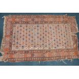 A Persian rug, with a geometric design of small flowers, within multiple borders, 170cm x 102cm.