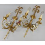 A pair of gilt metal two branch wall lights, cast with lion masks, flowers, leaves, bows, etc, in