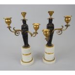 A pair of 19thC bronze gilt metal and marble three branch candelabra, with a central female