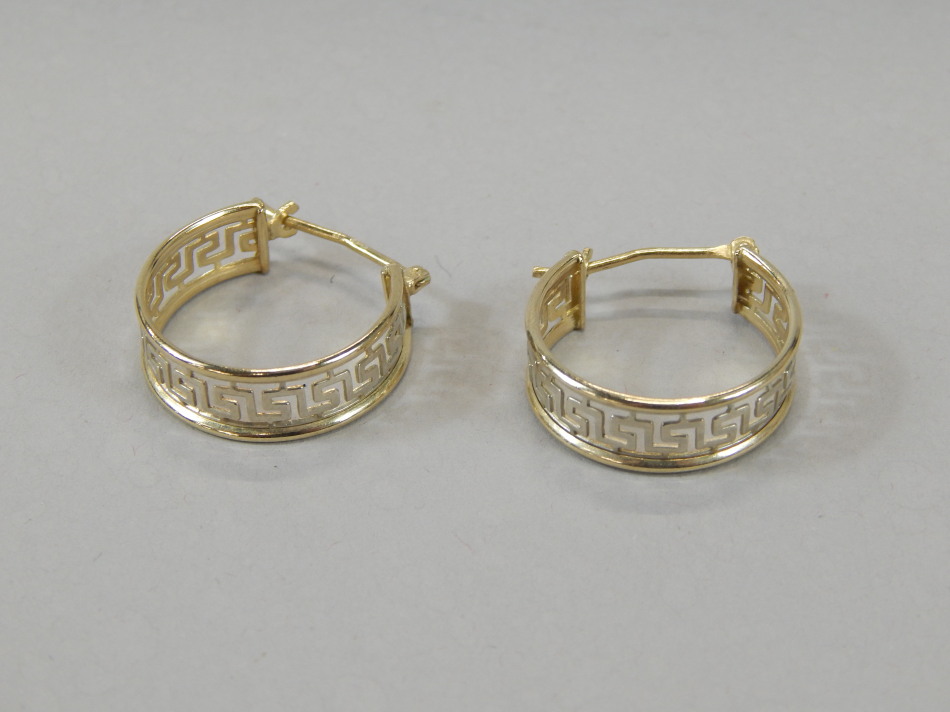 A pair of half hoop earrings, of 'C' shaped outline, with plain hooks and a Greek key centre, yellow