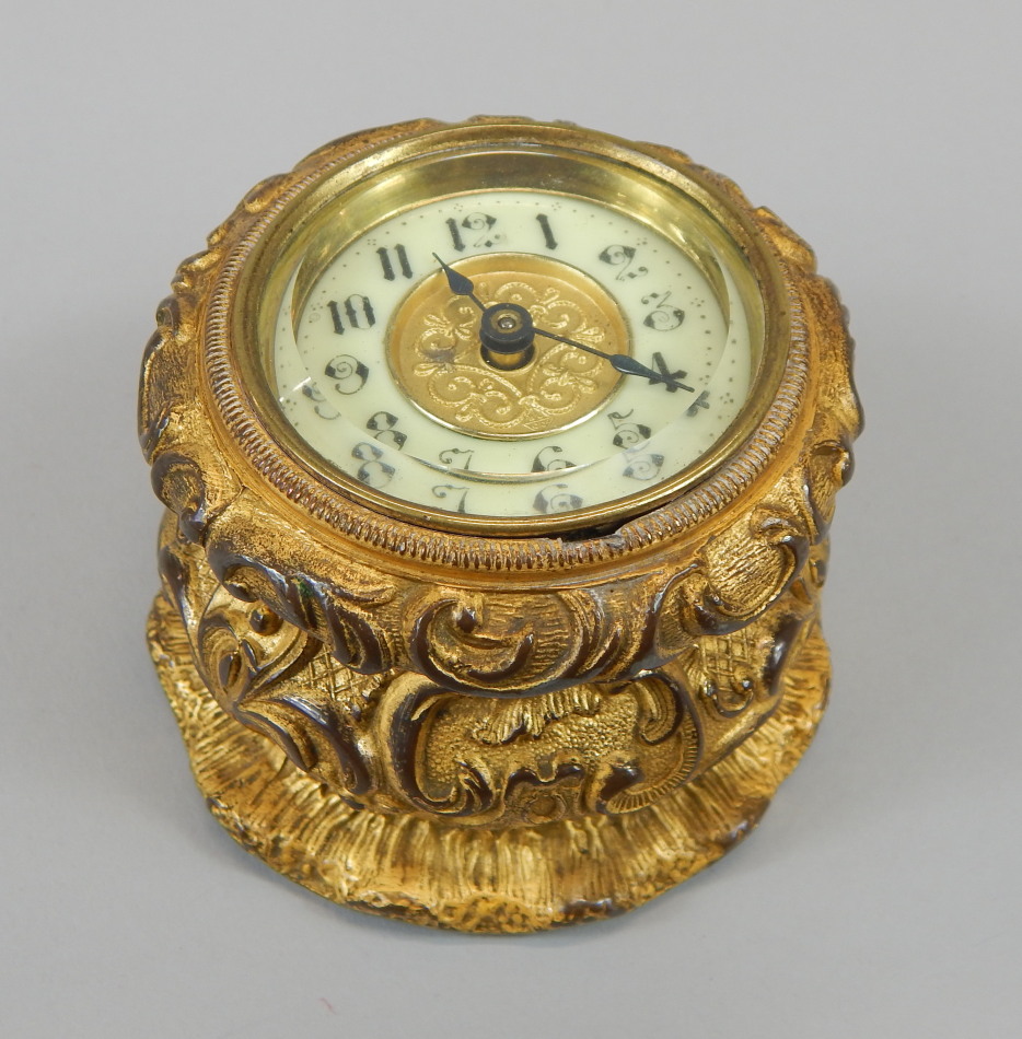 A late 19th/early 20thC French style gilt metal table clock, the enamel style dial with Arabic