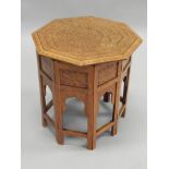 An early 20thC Indian hardwood occasional table, the octagonal top inlaid in brass and copper, and