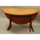 A retro style teak oval drop leaf dining table, on shaped supports, 129cm wide