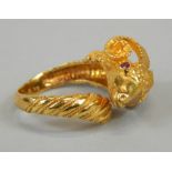A ram's head ring, the head set with two rubies, yellow metal, marked 750, 9.1g all in.