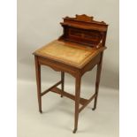 An Edwardian mahogany and simulated marquetry desk, with a raised back, sloping Davenport type