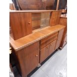 A Retro style Nathan sideboard, the raised back with two sliding glass doors, the base with an