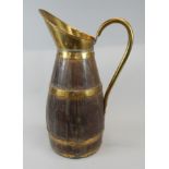 A late 19th/early 20thC oak and brass coopered jug, 64cm high Provenance: Butterfields, Thoresby