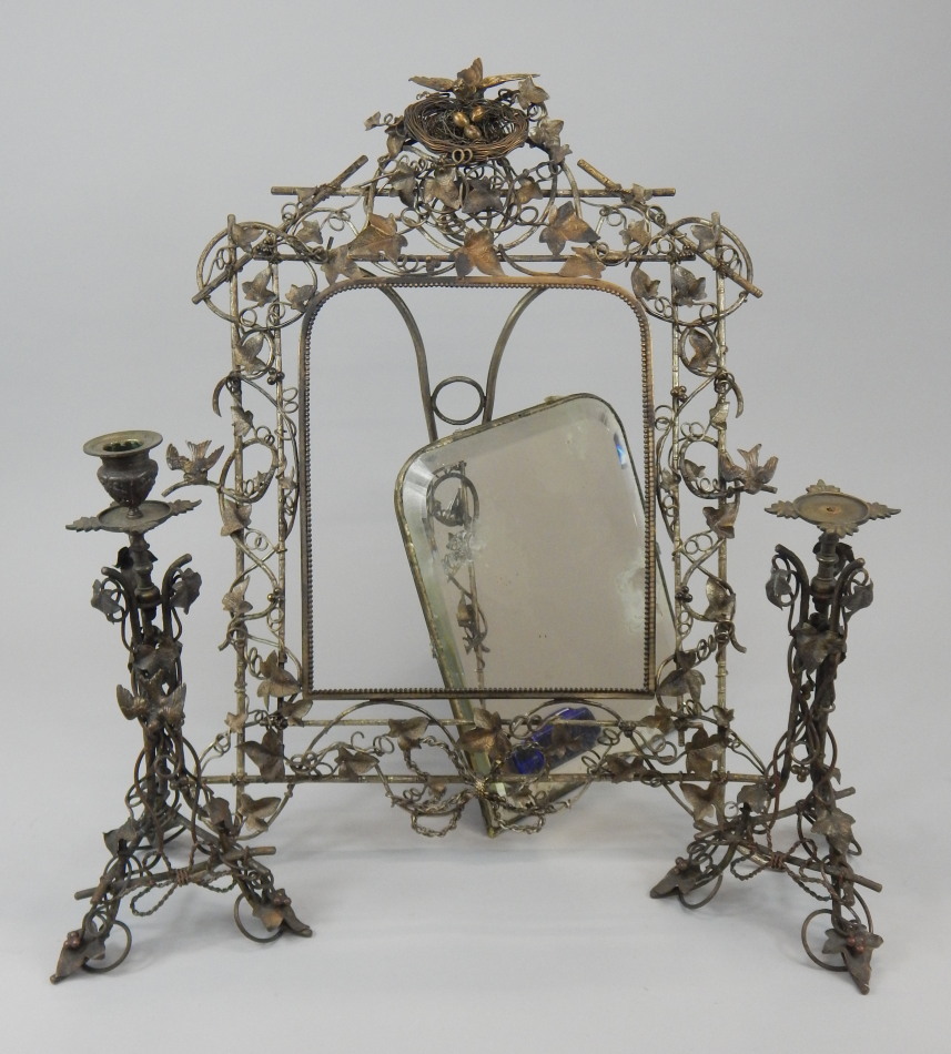 A Victorian silvered metal rectangular wall mirror, the frame elaborately cast with leaves, birds,