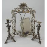 A Victorian silvered metal rectangular wall mirror, the frame elaborately cast with leaves, birds,