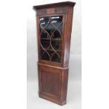 A 19thC mahogany corner cabinet, the top with an astragal glazed door, the base with a plain