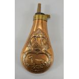 A copper and brass powder flask, decorated with grouse and gundogs.