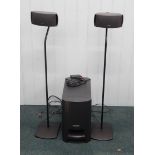 A Bose digital home theatre speaker system, comprising two small speakers, sub woofer, remote