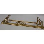 An Art Nouveau style brass fire curb, with leaf cast supports, 127cm wide. Provenance: Butterfields,