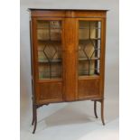 An Edwardian mahogany and marquetry display cabinet, with two astragal glazed doors, and splay legs,