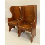 A pair of Arts & Crafts style solid oak wingback type chairs, each in the form of a church