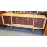A retro style melamine and walnut veneered sideboard, of low form, with an arrangement of three