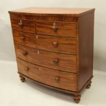 A Victorian mahogany bow fronted chest, with two short and three long drawers, each with turned wood