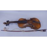 An early 20thC violin, with a two piece back stamped Nach Hopf, length of back 36cm, and a bow,