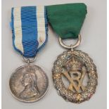 Two medals. A silver Victoria Volunteer medal, with green ribbon, and a Victoria 60 Years