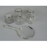 Various silver mounted dressing table items, to include four jars, a scent bottle, and a hand