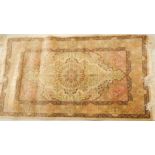 A 20thC silk Qum rug, a central medallion decorated overall with flowers, on a beige ground,