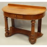 A Victorian mahogany bow fronted wash stand, with a frieze drawer, on turned reeded legs, 105cm