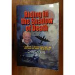 A copy of Riding in the Shadow of Death by Chris Keltie, signed by various people involved in this