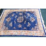 A Chinese blue wool cut rug, decorated with flowers, etc, 354cm x 248cm. Provenance: Butterfields,