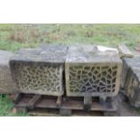 A matched pair of sandstone ornate corner blocks.