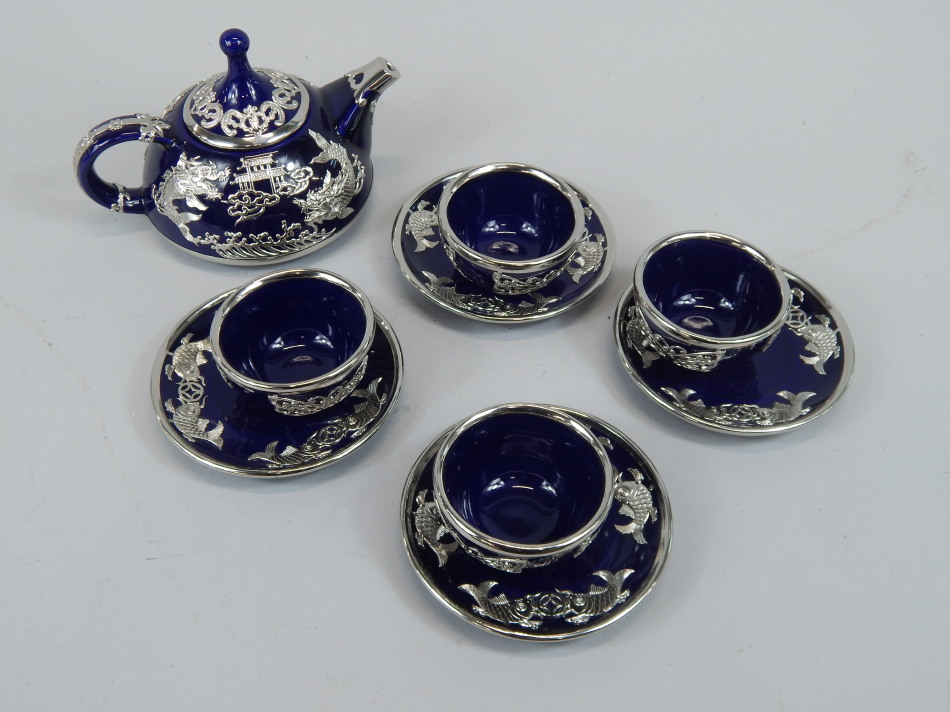 A modern Oriental tea or coffee set, comprising teapot, four cups and saucers, each with white