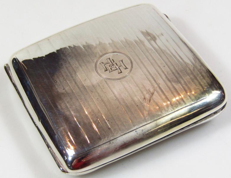 A George VI silver cigarette case, of part engine turned rounded outline, with a fitted interior,