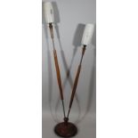 A retro teak two pronged lamp standard, with frosted glass shades raised with star motifs, on