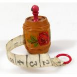 A 20thC French treen Stanhope tape measure, of barrel outline decorated with flowers, with