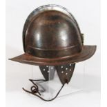 A Cromwellian style tin soldier's helmet, of shaped outline, 20thC construction, 26cm high.