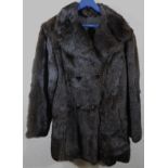 An early 20thC ladies fur coat, quarter length with double set buttons to the front, size unknown.