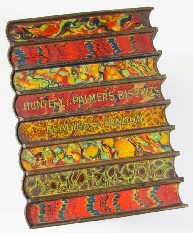 An early 20thC biscuit tin, by Huntley & Palmers, in the form of books with a strap work centre - Image 3 of 3