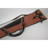 A canvas and leather shoulder gun case.