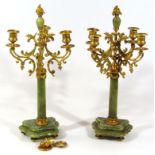 A pair of four branch candelabra garniture, each on fluted columns and shaped bases, with four urn