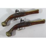 A pair of replica brass and walnut flint lock pistols, 40cm.