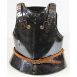 A Cromwellian style armour breast plate, with shaped shoulder sections and part leather strapping,