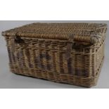 An early 20thC wicker picnic hamper, of rectangular outline with rounded corners and leather