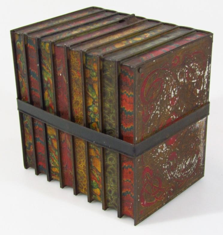 An early 20thC biscuit tin, by Huntley & Palmers, in the form of books with a strap work centre - Image 2 of 3