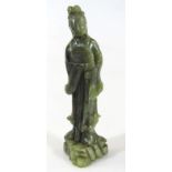 A 20thC Chinese green jade figure of a standing lady holding fan, in flowing robes, on shaped