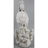 A 20thC Chinese semi porcelain blanc-de-chine figure of a lady, in flowing robes aside dragon,