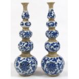 A pair of Kangxi style Chinese porcelain blue and white gourd vases, with trumpet shaped stems, blue