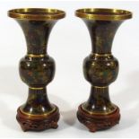 A pair of 20thC Chinese cloisonné vases, each trumpet shaped top and bulbous stem profusely