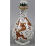 A Chinese porcelain sake bottle, the bulbous body polychrome decorated with dragons in geometric