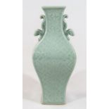 A Chinese porcelain celadon vase, of square shouldered form with moulded dragon handles on square