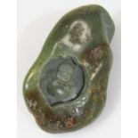 A 20thC Chinese green jade carving, centred by Buddha with a shaped outline, unmarked, 8cm wide.
