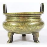A Chinese bronze censer, the circular bombe body engraved with various flower heads, petals, and